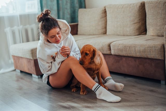 person sitting on the floor with a dog